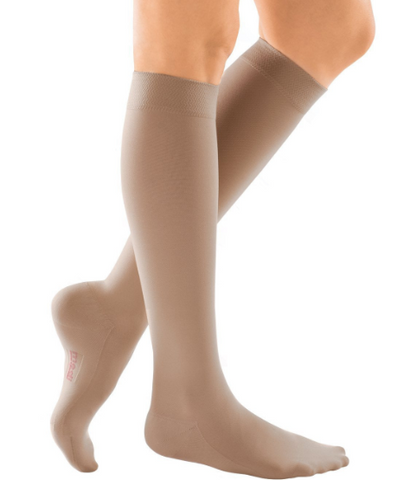 pair of beige knee high compression socks