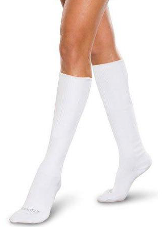 person wearing white knee high compression socks