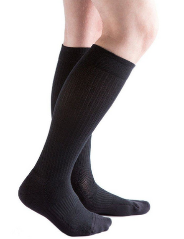 person wearing black knee high compression socks