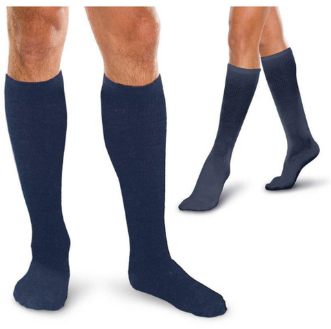 pair of navy blue knee high compression socks shown on a person from two different angles