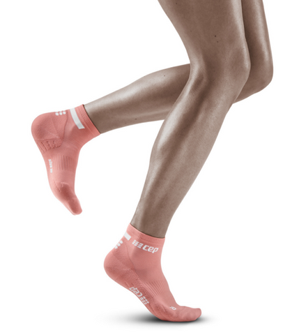 person wearing pink ankle length compression socks